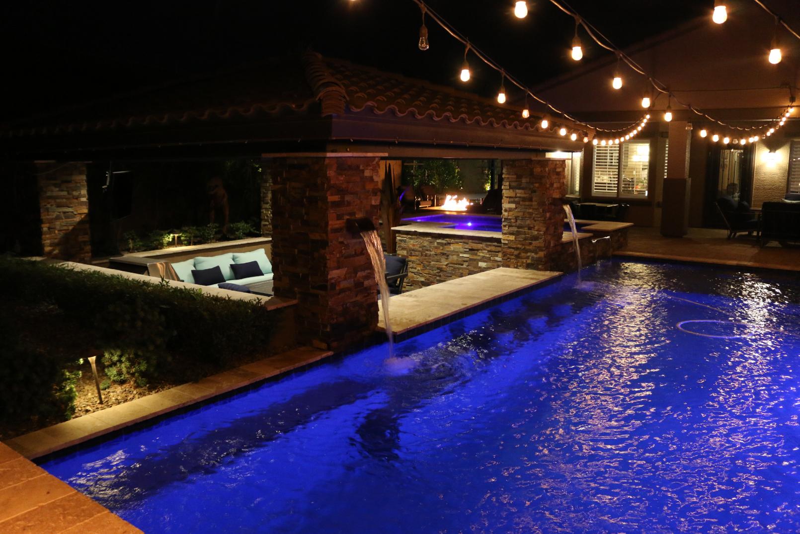 Elegant water feature with pool and waterfall in a backyard
